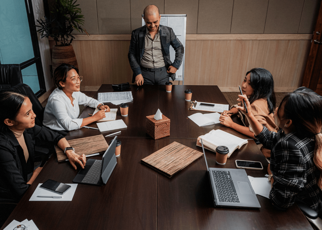 group of coworkers or business people having a meeting in a board room